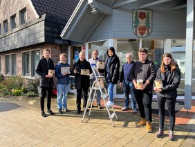 Bürgermeister Guido Heinisch und das Team von LUPO mit den gebauten Nistkästen. Bild: VHS Hatten + Wardenburg