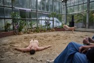Bild: Eiko Braatz Teil der Tanzperformance: Der Tänzer liegt auf dem Rücken im Sand. Die Tänzerin lehnt in einem Stuhl.