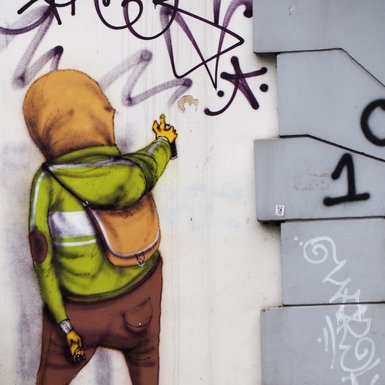 Ein Graffiti einer Person, die ein Graffiti sprüht.