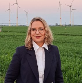 Bild: privat Claudia Kemfert vor einem Feld mit Windkraftanlagen