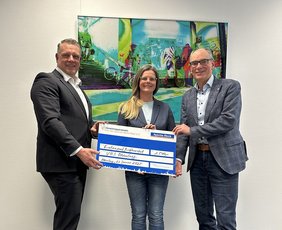 Bild: VHS Oldenburg Herrmann Kruse überreicht dem VHS-Geschäftsführer Andreas Gögel und Bildungsmanagerin Anita Groth einen symbolischen Scheck. Bild: VHS Oldenburg